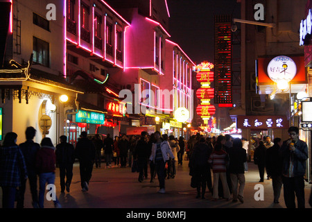 Busy nightlife in the main shopping street in Suzhou with many  shop signs,people and illuminations Stock Photo