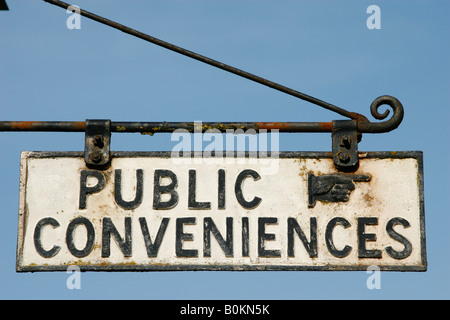 Old fashioned public convenience sign in Cotswold village in the UK Stock Photo