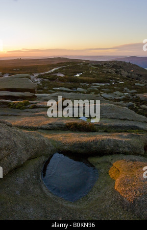 Dawn light on the Derwent Edge, looking out towards the Salt Cellar and the Wheel Stones with a pool of ice in the foreground. Stock Photo