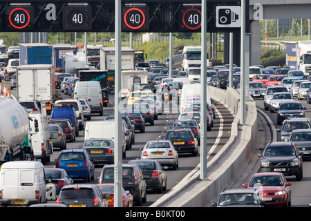 Traffic congestion for cars and trucks in both carriageways on M25 motorway London United Kingdom Stock Photo