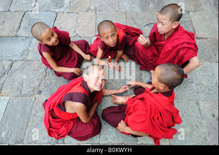 Young Bhutanese Buddhist monks resting from studies at the Wangdue Phodrang Monastry Dzong  in central Bhutan. Stock Photo