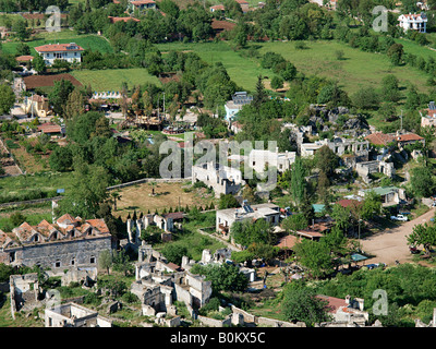 LOOKING DOWN FROM HILLSIDE ON THE DERELICT GREEK VILLAGE OF LEVISSI,   KAYAKOY WITH PRESENT DAY VILLAGE OF KAYA  TURKEY Stock Photo