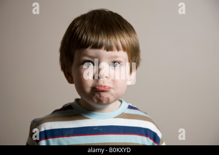 Sad face A young boys makes a sad face expression Stock Photo - Alamy