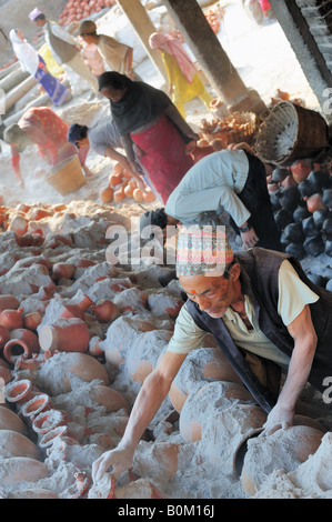 Communal pottery kiln being emptied in Bhatapur Nepal Kathmandu Valley. Traditional craft workers in a cooperative scheme. Stock Photo