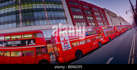 long line of traditional double deck buses on oxford street london Stock Photo