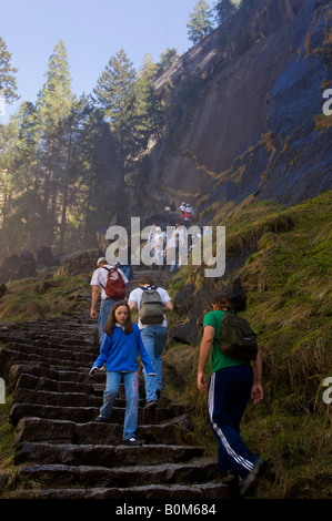 Hikers climbing on the steep rocky staircase stairs of the Mist Trail Yosemite National Park California Stock Photo