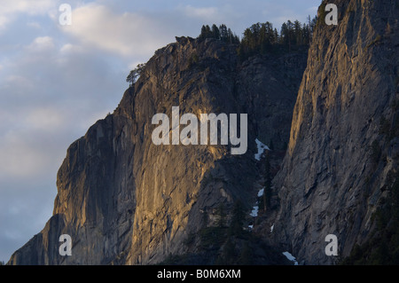 Morning light on sheer granite cliffs in Yosemite Valley Yosemite National Park California Stock Photo