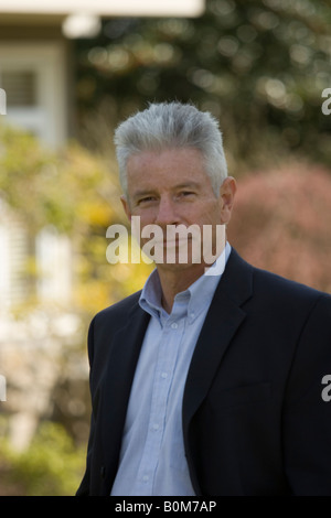 Portrait of a real estate agent standing outdoors in a residential neighborhood Stock Photo