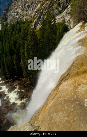 Overlooking the edge of Vernal Fall waterfall along the Merced River Yosemite National Park California Stock Photo