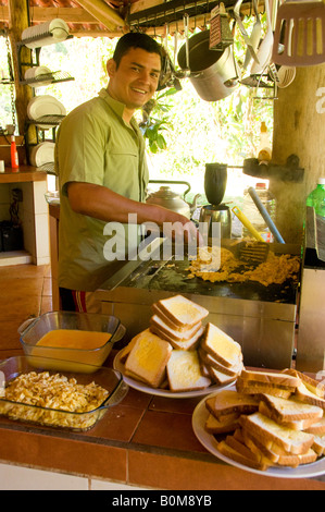 COSTA RICA River Guide cooking breakfast for rafting group at Pacuare River Lodge Caribbean Slope Stock Photo