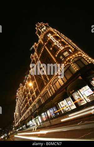 City of London, England. Angled night view of the Harrods department store located in Knightsbridge’s Brompton Road. Stock Photo