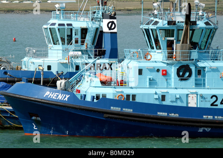 Blue berthing tugs Thrax and Phenix on Southampton Water southern England UK Stock Photo