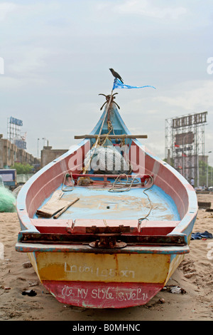 A colourful wooden fishing boat moored up on Marina Beach in Chennai, India Stock Photo