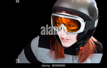 Portrait of a cute girl with red hair snowboarding on a winter background Studio shot composite Stock Photo