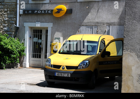 A typical yellow La Poste van outside of the rural post office in Lussan, Grad, France. Stock Photo