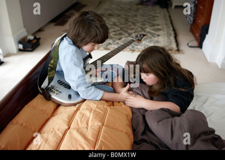 A brother and sister playing at home. Stock Photo