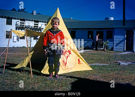 Boy dressed up as a cowboy in front of his tepee, c. 1955 Stock Photo