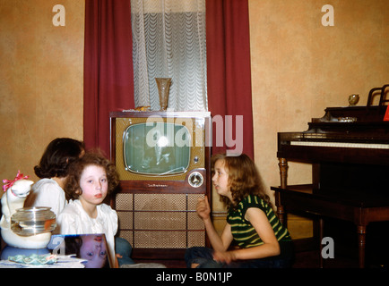 Three girls find that there is nothing worth watching on the TV, USA, c. 1955 Stock Photo