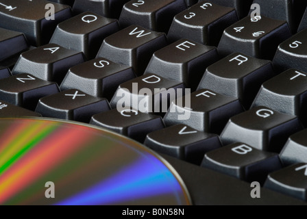 Close up of computer keyboard and reflective side of DVD disk 2008 Stock Photo