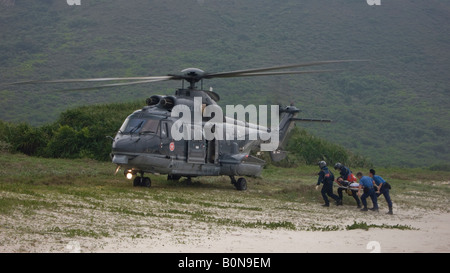 Hong Kong Government flying service helicopter rescue swimmer from Dai long wan beach Stock Photo