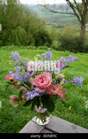 Vase of spring and early summer flowers in rural England. Stock Photo