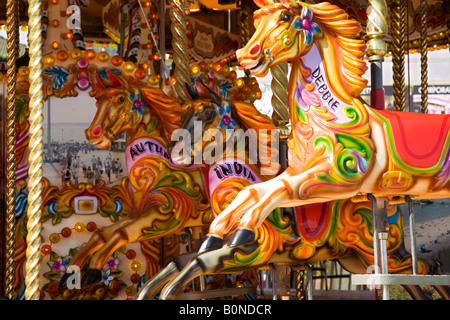 Carousel fairground ride horses colourful traditional roundabout seaside holidays fun children Stock Photo
