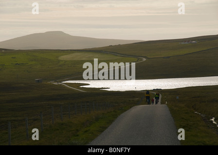 Cyclists on a road on Bressay Island, Shetland Islands, Scotland, UK Stock Photo