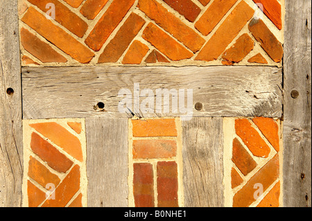 Close up of Elizabethan timber framed building with red bricks Stock Photo