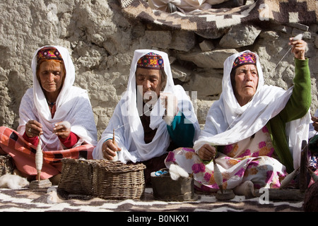 Women spin wool together in mountain village of Altit in Hunza region of Karokoram Mountains Pakistan Stock Photo