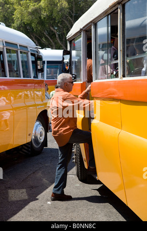 Maltese buses and passengers at Funtana tat-Tritoni  Valetta   Leyland DAF Bus front & Grille, Malta. Stock Photo