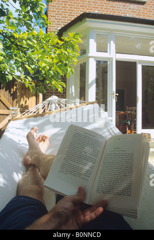 Reading In Hammock Stock Photo