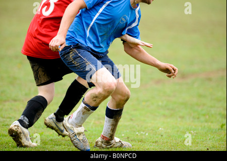 Park life football: two players battle for possession of the ball in a non-league pub team clash. Stock Photo