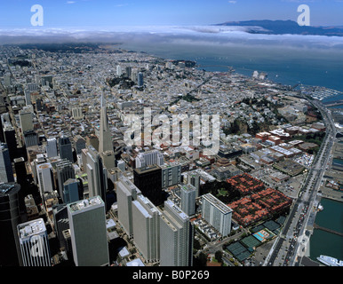 aerial above San Francisco Embarcadero Center and Transamerica pyramid with view to Golden Gate in fog Stock Photo