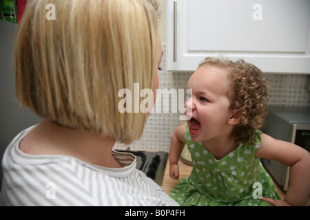 Toddler having a temper tantrum and screaming at her mother Stock Photo
