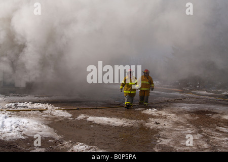 Two firefighters move to rest Stock Photo
