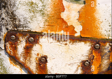 Close up of rusty metal fitting on a white wood boat Stock Photo