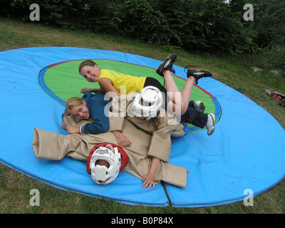 girl students sumo wrestling at school camp Stock Photo