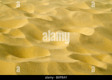 Horizontal close up of the patterns made in the sand on the beach by the wind on a sunny day. Stock Photo