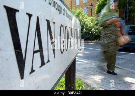 a woman in a sari passes a street sign for van gogh close, in isleworth, in the london borough of hounslow, middlesex, england Stock Photo