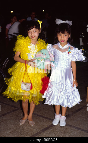 Girls dressed up in their finest for a Sunday walk. Ho Chi Min City, Vietnam. Stock Photo