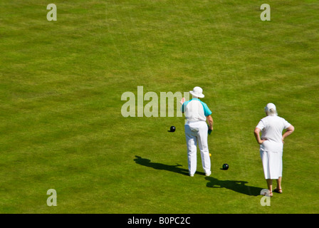 Horizontal aerial view of two ladies in a game of bowls with the skipper giving guidance at the 'Head' during an end. Stock Photo