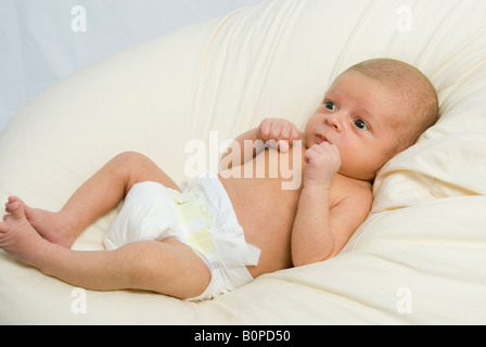 Newborn Baby Boy Joshua Kailas Hudson Aged 20 days Lying in Beanbag Stock Photo