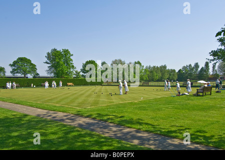 An wide angle view of elderly people during a bowls match on a sunny day in Rye. Stock Photo
