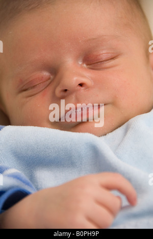 Close Up on Face of Sleeping Newborn Baby Boy Joshua Kailas Hudson Aged 20 days Blowing Bubbles Stock Photo