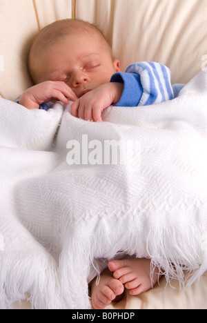 Sleeping Newborn Baby Boy Joshua Kailas Hudson Aged 20 days and White Blanket Stock Photo