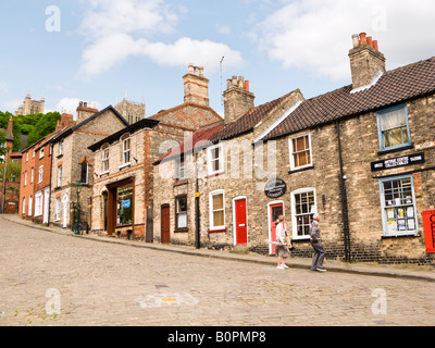 Old shops and houses at the bottom of Steep Hill in Lincoln city, England, UK Stock Photo