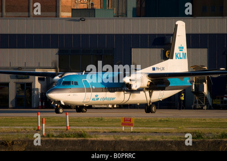 Commercial aircraft Fokker 50 KLM taxiing at London City Airport, England, UK Stock Photo
