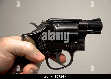 Finger on the trigger of a Smith and Wesson 38 caliber snub nose revolver Stock Photo