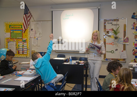 Fourth grade elementary school teacher uses an overhead projector in a classroom in Tampa Florida Stock Photo
