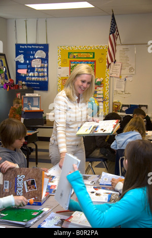 Female fourth grade teacher with students in a classroom in Tampa Florida Stock Photo
